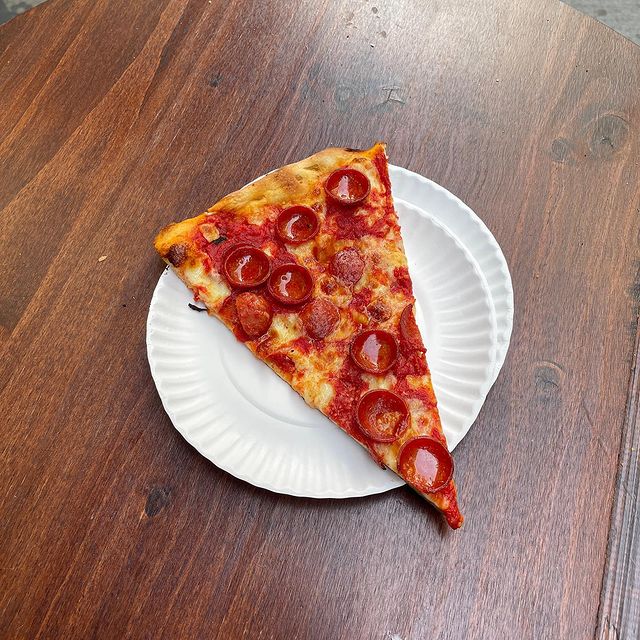 A slice of pizza from Artichoke Basille's Pizza - Times Square location